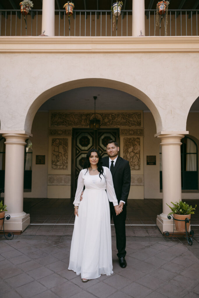 Man and woman posing for their Balboa Park engagement photos