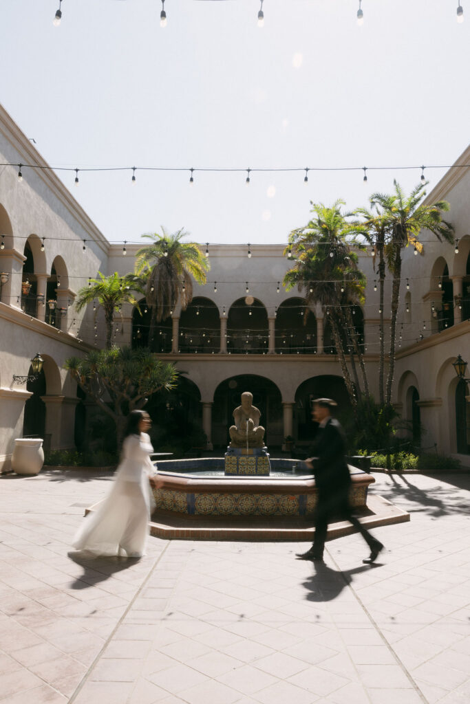 Man and woman running towards each other for their San Diego engagement session