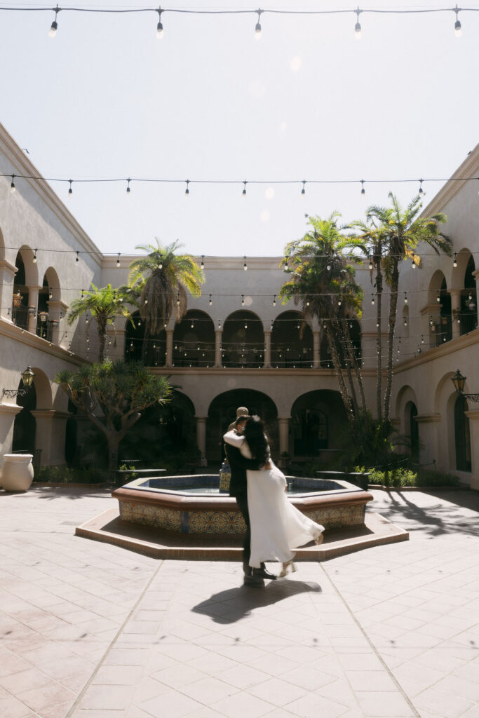 Man lifting and twirling his fiancé during their engagement shoot