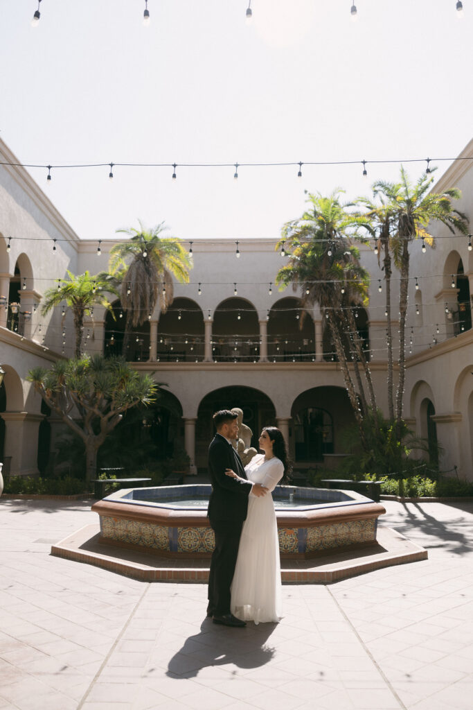 Man and woman posing for their engagement photos in Balboa Park