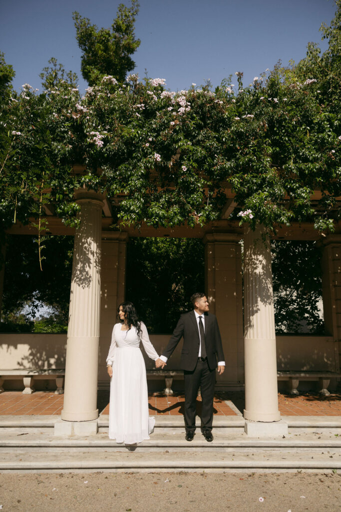 Couple holding hands during their editorial engagement photos in California