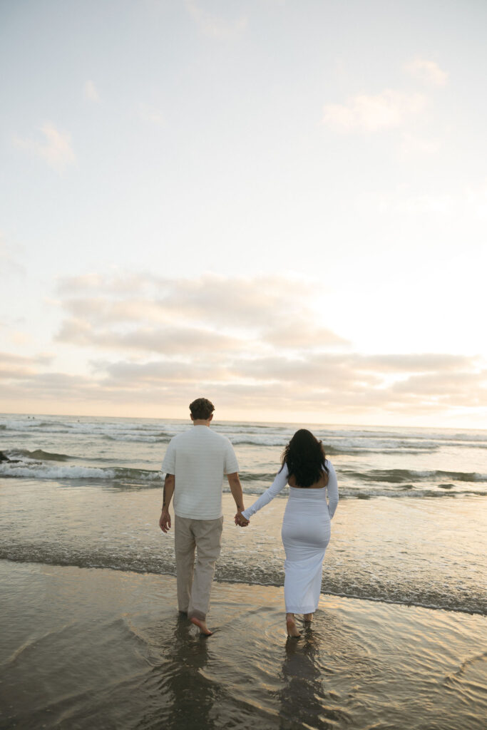 Man and woman walking towards the water