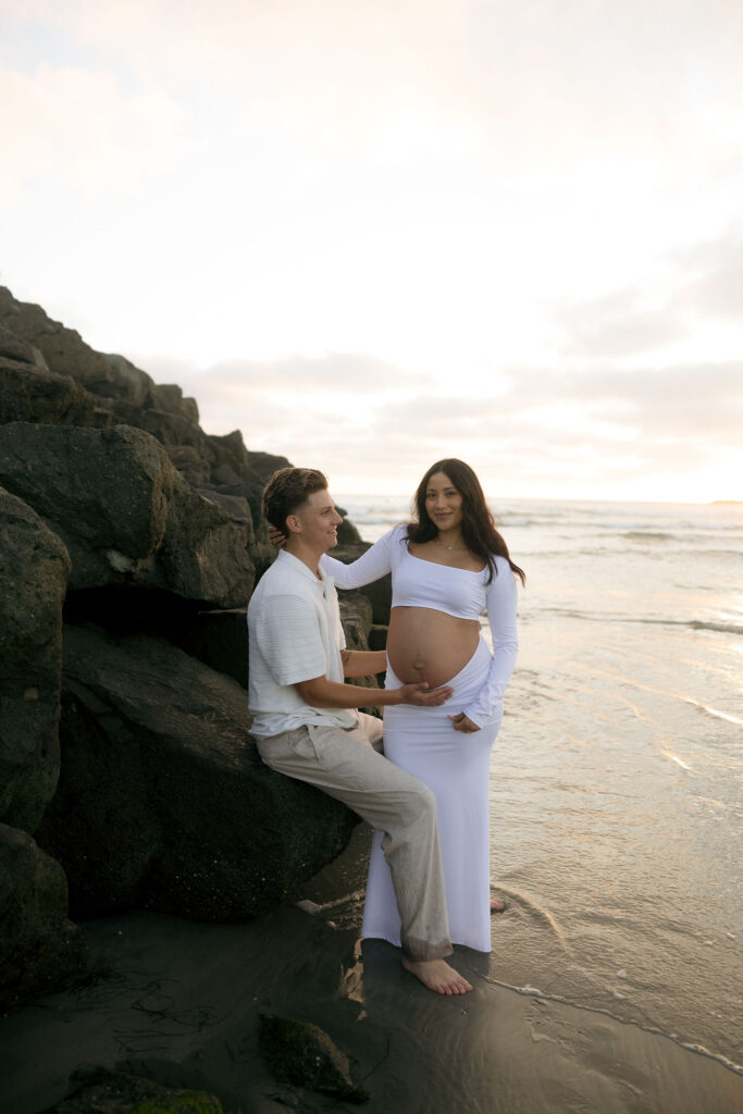 Man and woman posing for their San Diego maternity photos