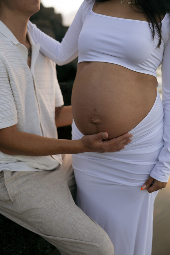 Close up of a man holding his pregnant wifes belly