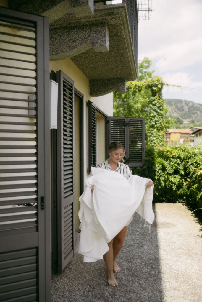 Bride carrying her wedding dress to her room