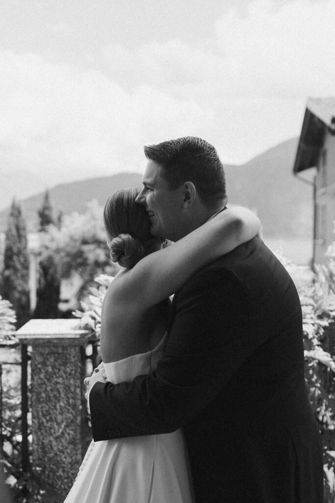 Black and white photo of a bride and groom sharing an emotional first look