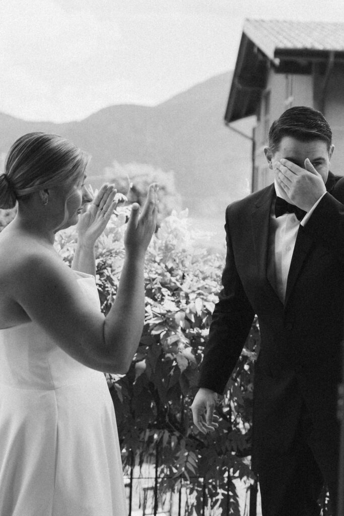 Black and white photo of a bride and groom sharing an emotional first look