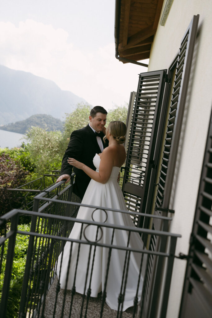 Outdoor bride and grooms portraits on the balcony of their Lake Como Airbnb