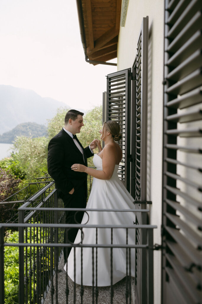 Outdoor bride and grooms portraits on the balcony of their Lake Como Airbnb