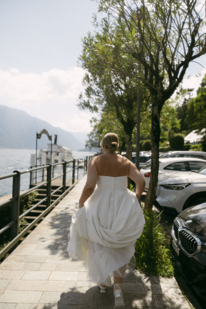 Bride walking to a boat on Lake Como