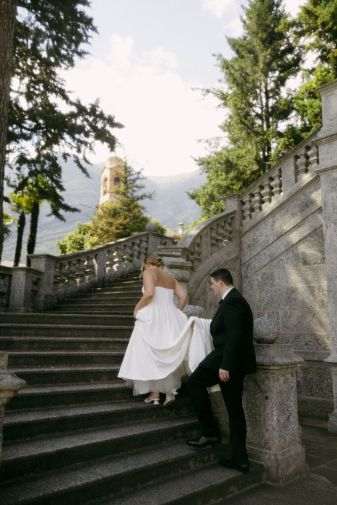 Bride and groom walking up a staircase during their outdoor portraits