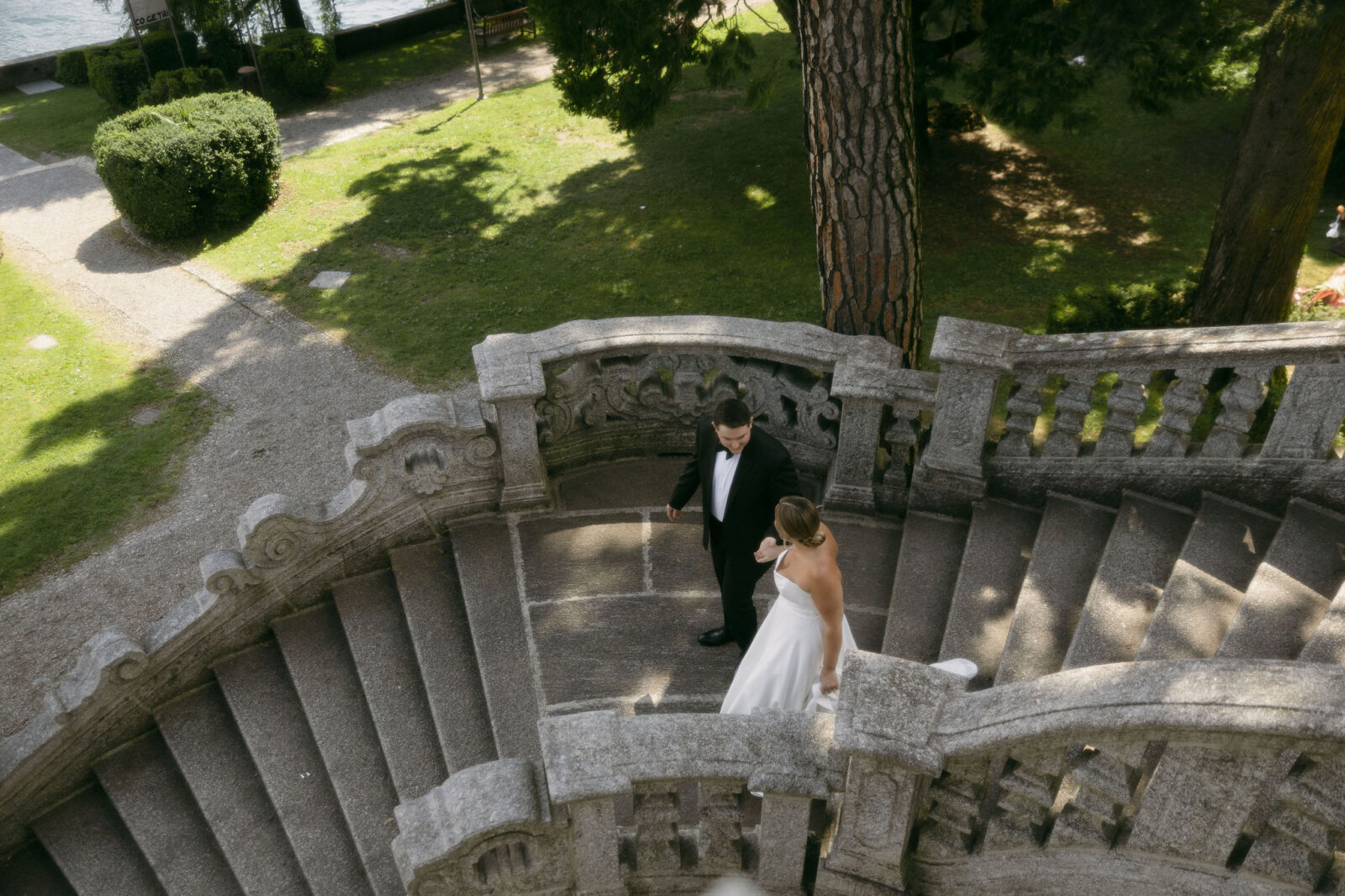 Bride and groom walking down a staircase in Lake Como