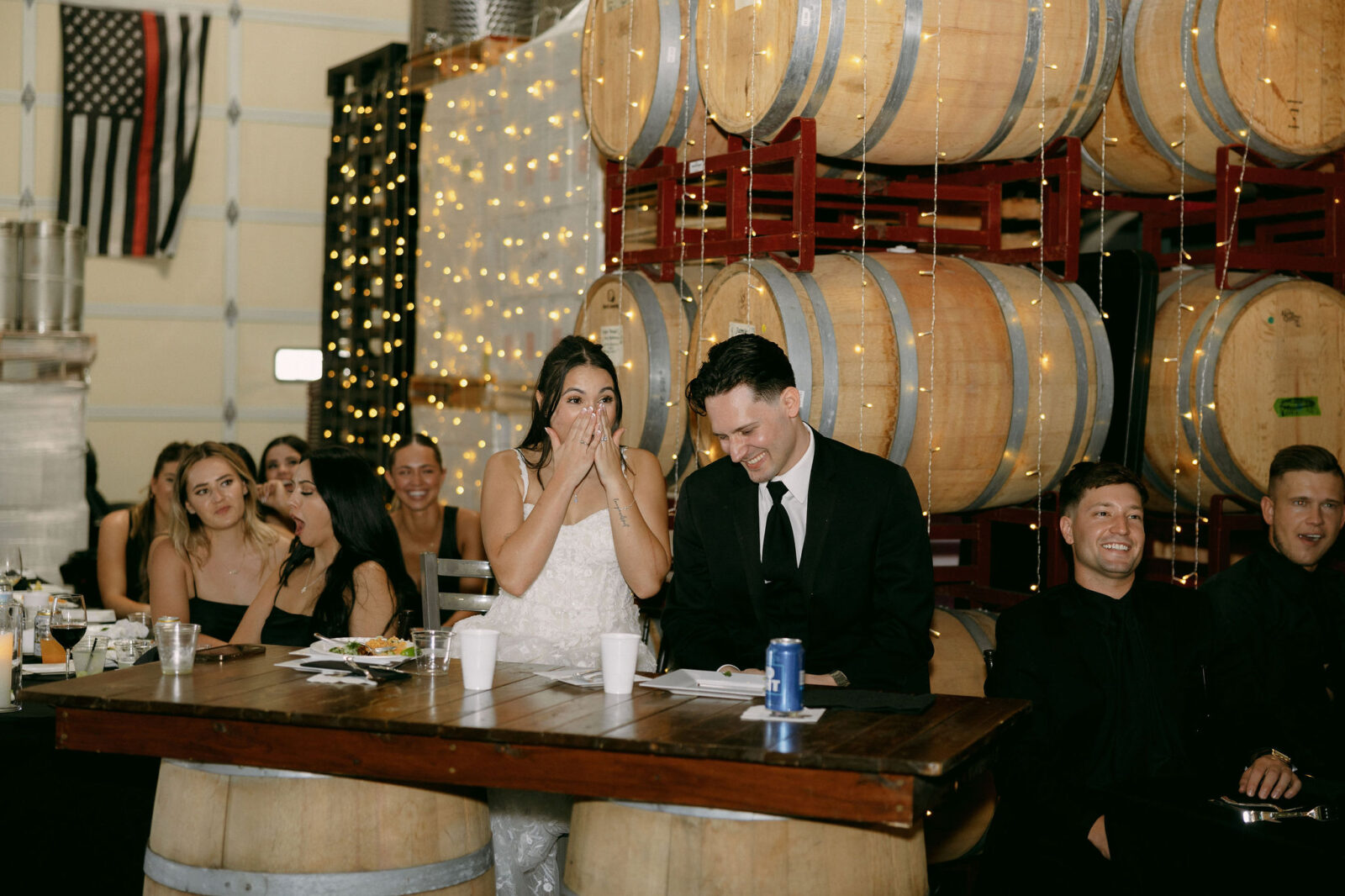 Bride and groom laughing during speeches