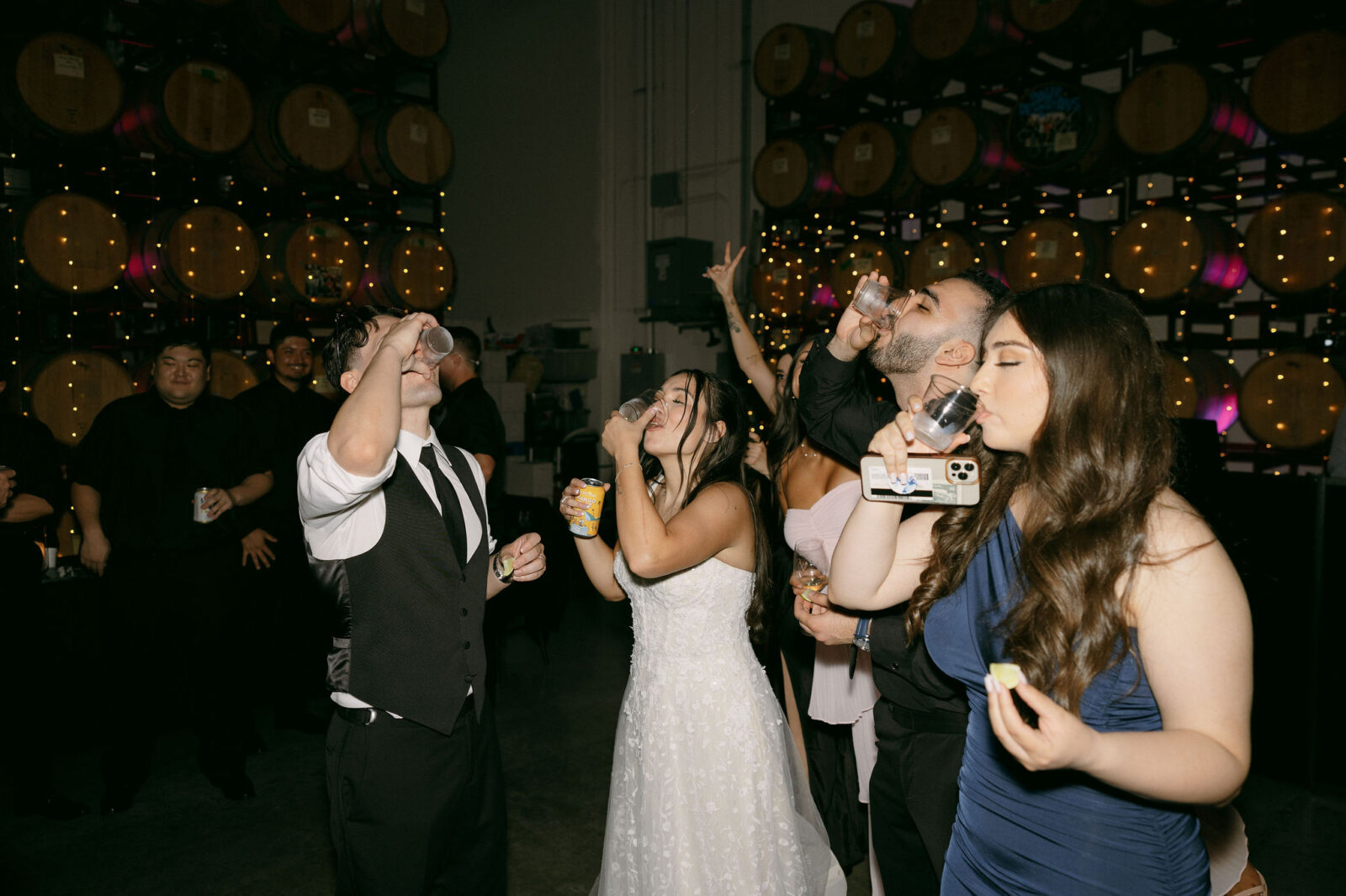 Bride and groom taking shots during their reception