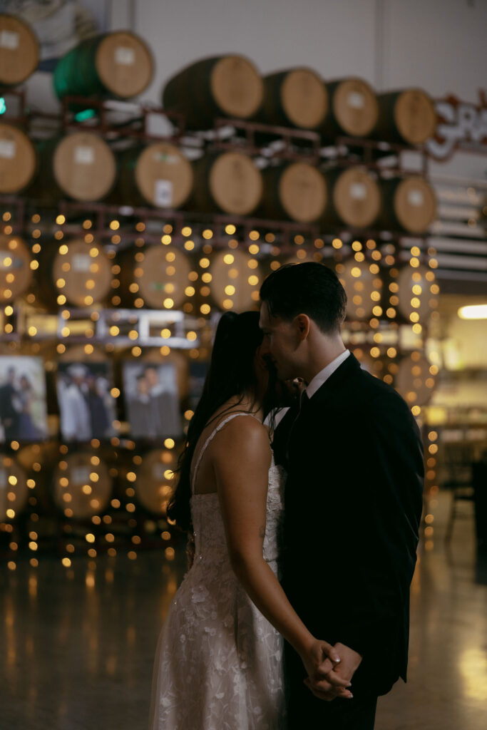 Bride and groom sharing a first dance during their indoor wedding reception at Grape Expectations in Las Vegas