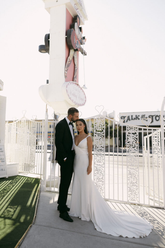 Bride and groom posing outside of The Little White Chapel in Las Vegas