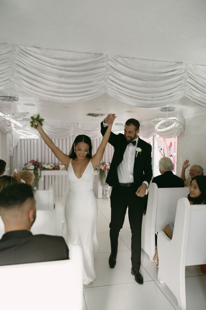 Bride and groom walking back down the aisle as husband and wife