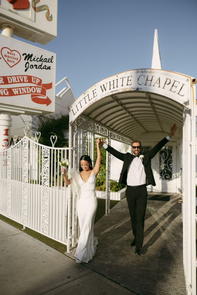 Bride and groom walking out of Little White Chapel