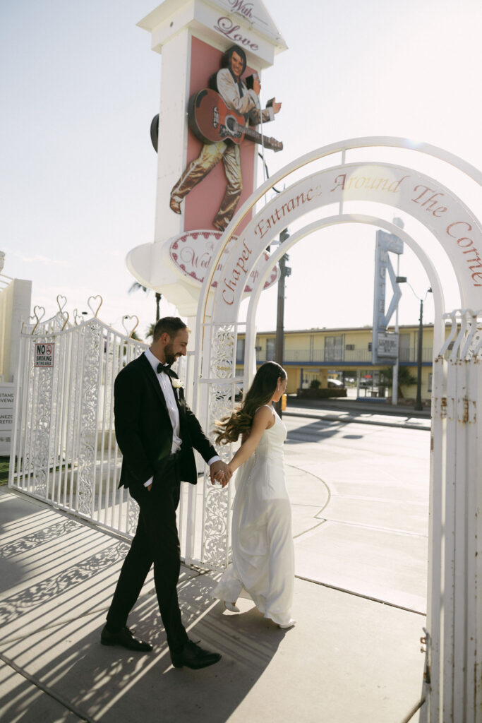 Bride and groom walking outside of The Little White Chapel