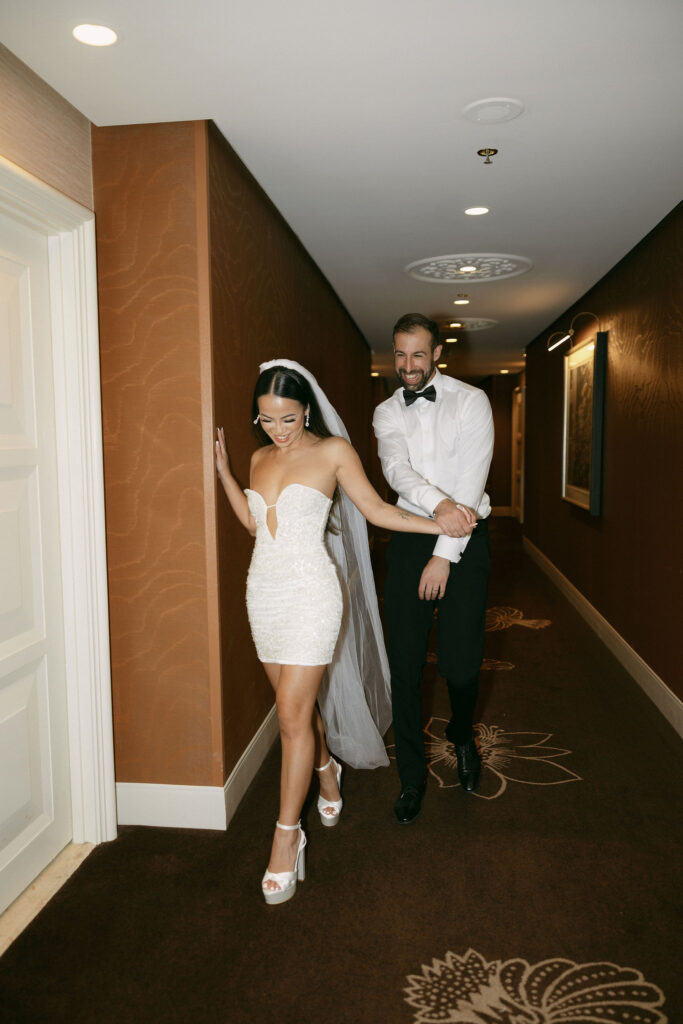 Bride and groom walking down the Wynn Las Vegas hallway