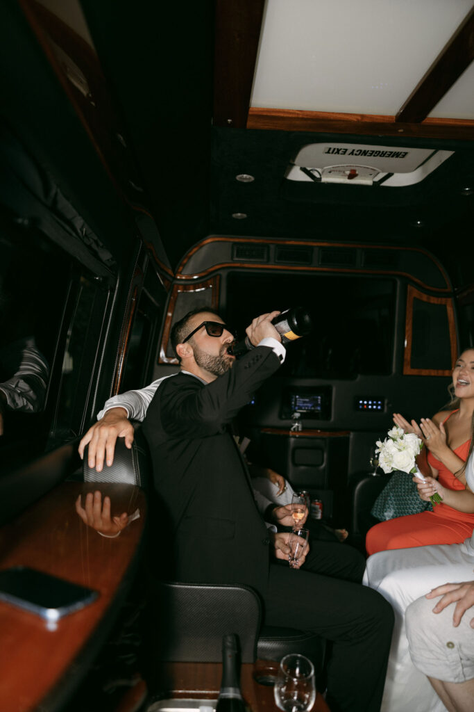 Groom drinking on the party bus