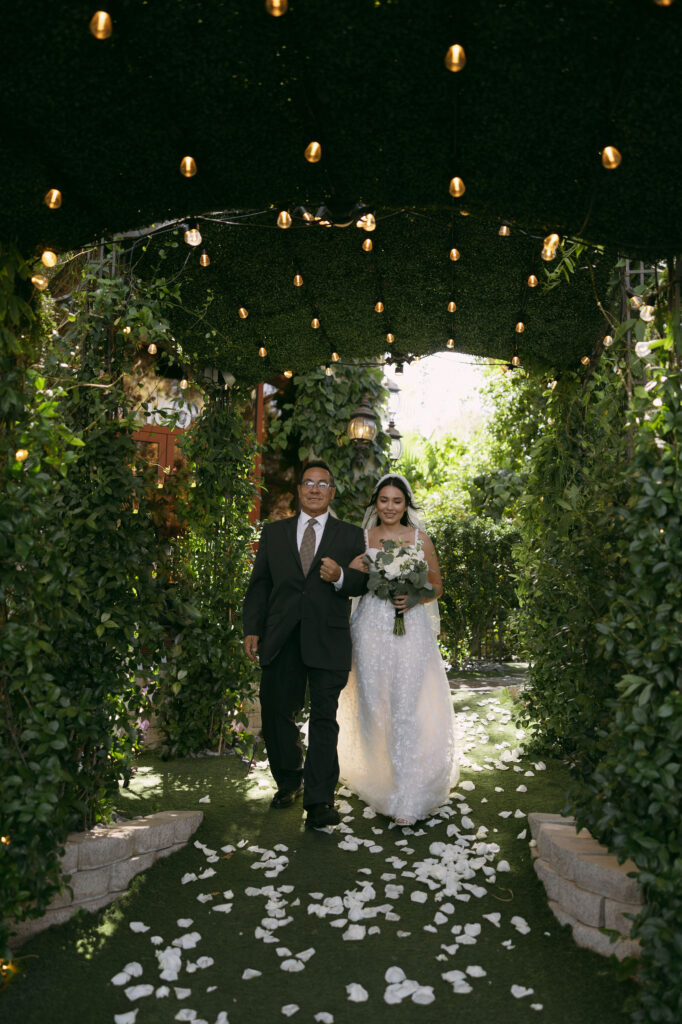 Bride being walked down the aisle by her father