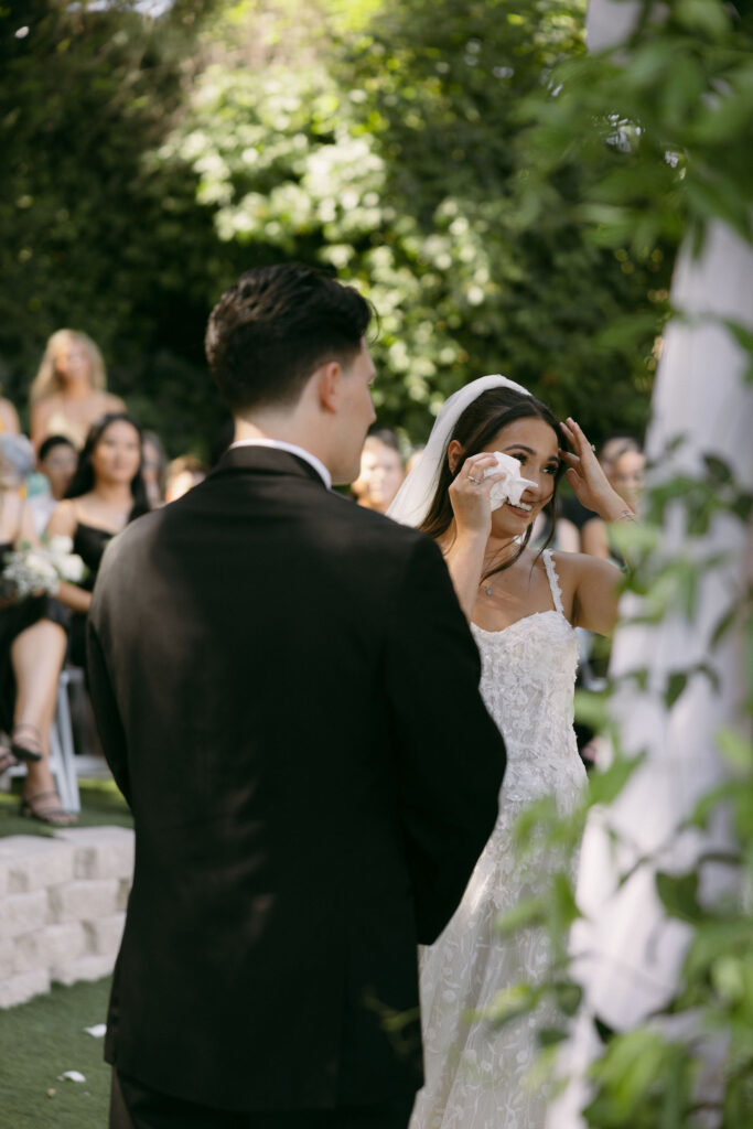 Bride getting emotional during her outdoor Lakeside Weddings and Events ceremony