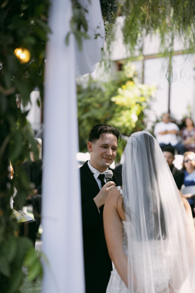 Groom saying his vows to his bride