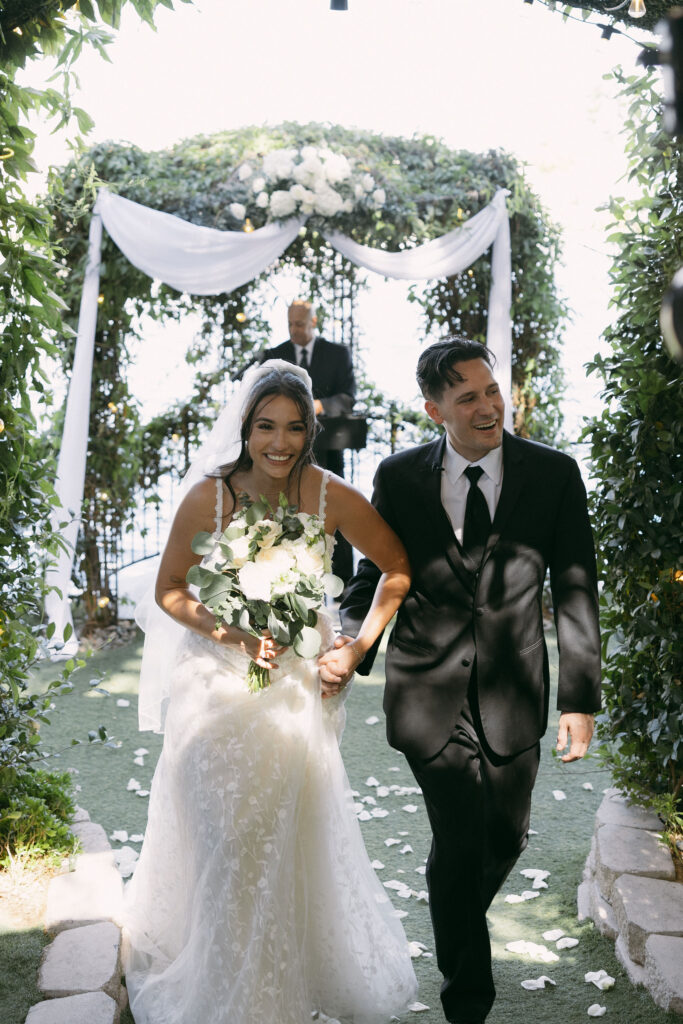 Bride and groom walking back down the aisle after their Lakeside Weddings and Events wedding ceremony