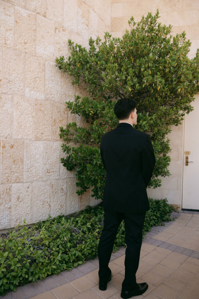 Groom waiting to share his first look with his bride