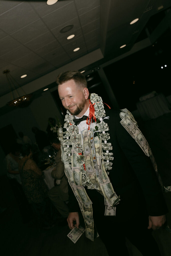 Groom wearing a money lei for a wedding reception money dance