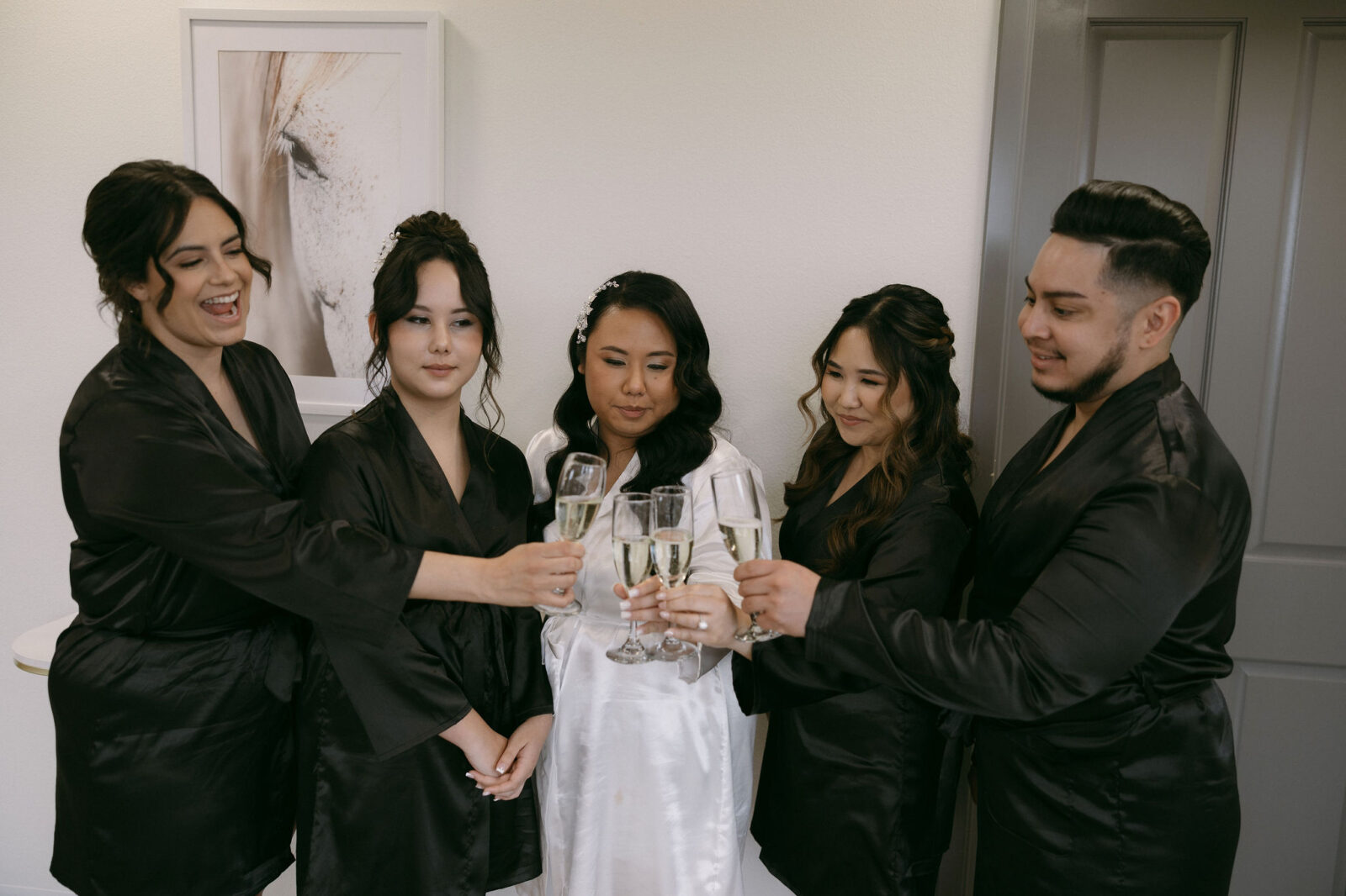 Bride and her wedding party toasting champagne