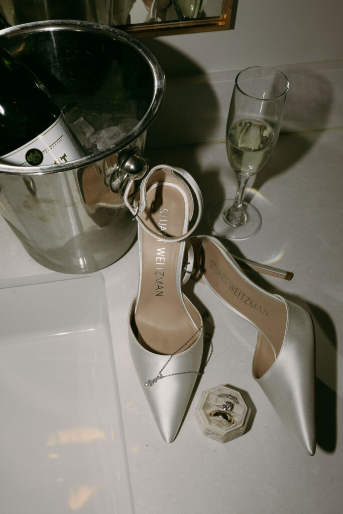 Las Vegas wedding details with champagne, heels, and jewlery