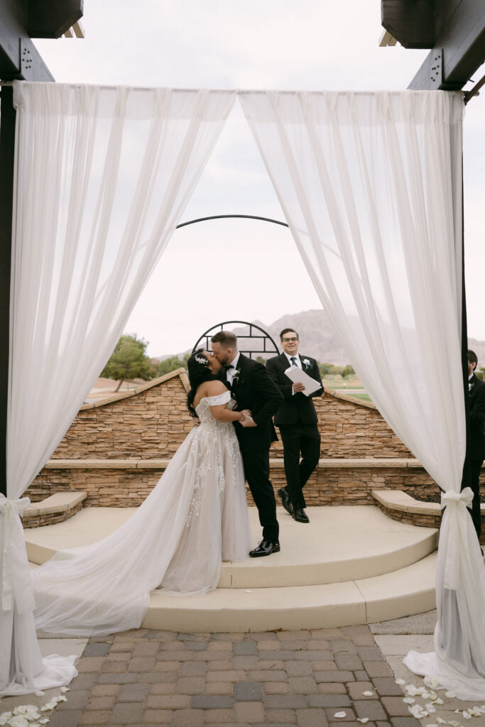 Bride and groom kissing during their Stallion Mountain wedding ceremony