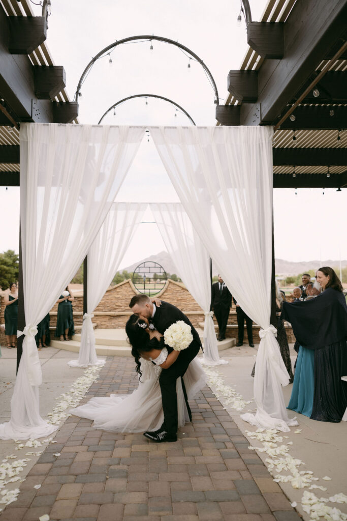 Bride and groom kissing during their Stallion Mountain wedding ceremony