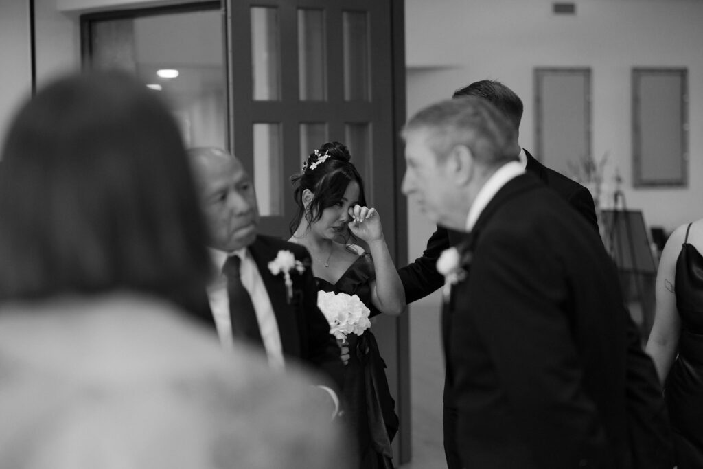 Black and white candid photo of a guests after the ceremony