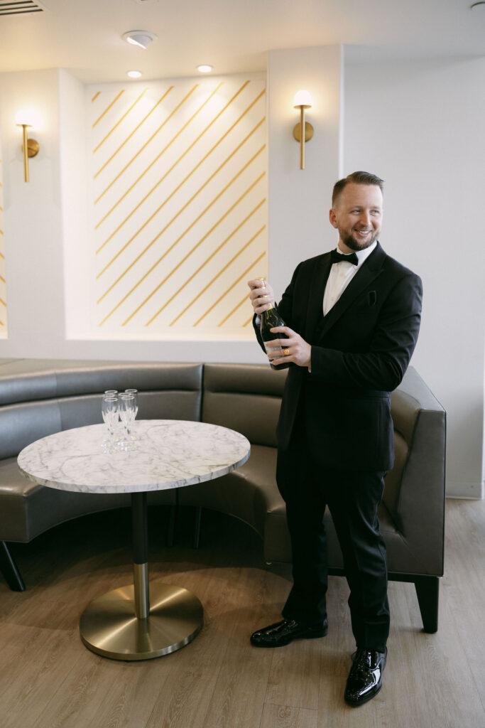 Groom pouring a drink for himself