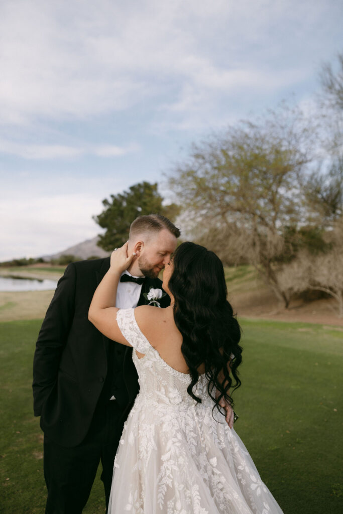 Bride and groom kissing during their outdoor Stallion Mountain wedding portraits