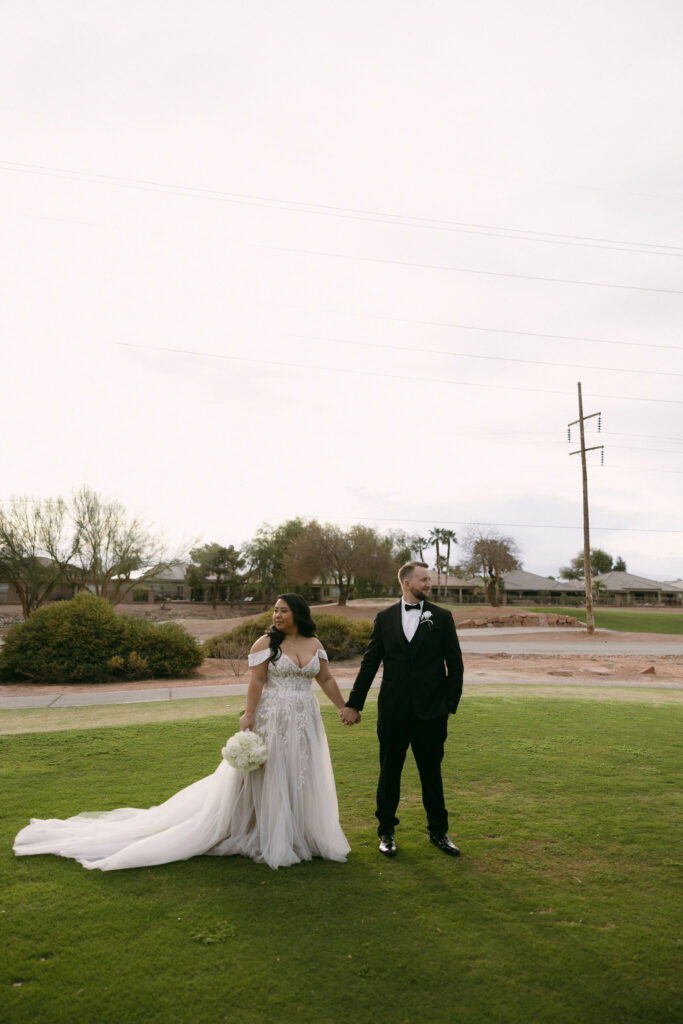 Bride and groom holding hands during their outdoor Stallion Mountain wedding portraits