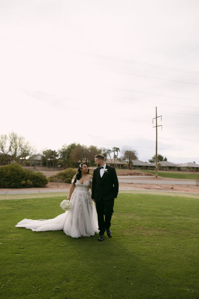 Bride and groom walking the gold course at Stallion Mountain wedding venue