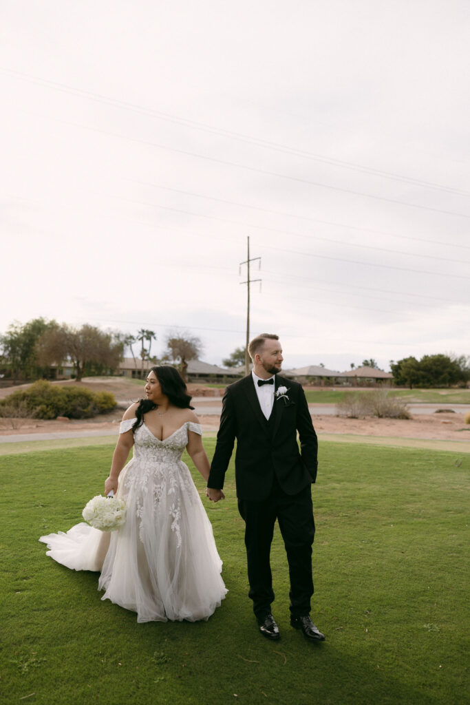 Bride and groom walking the gold course at Stallion Mountain wedding venue