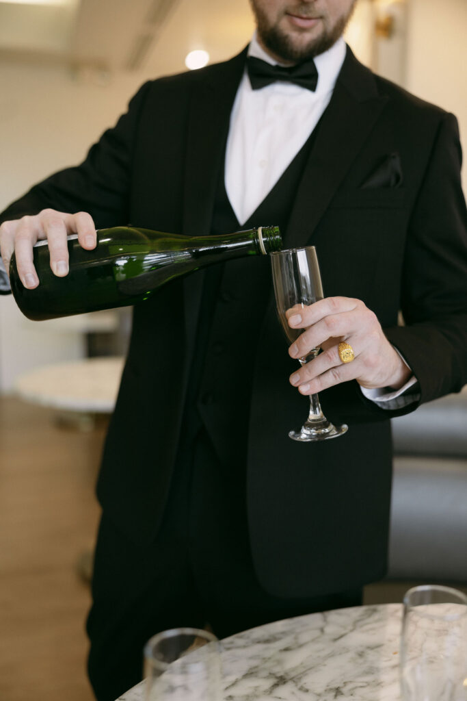 Groom pouring a drink for himself