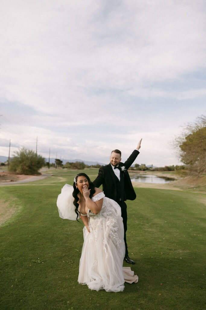 Groom pretending to spank the brides butt