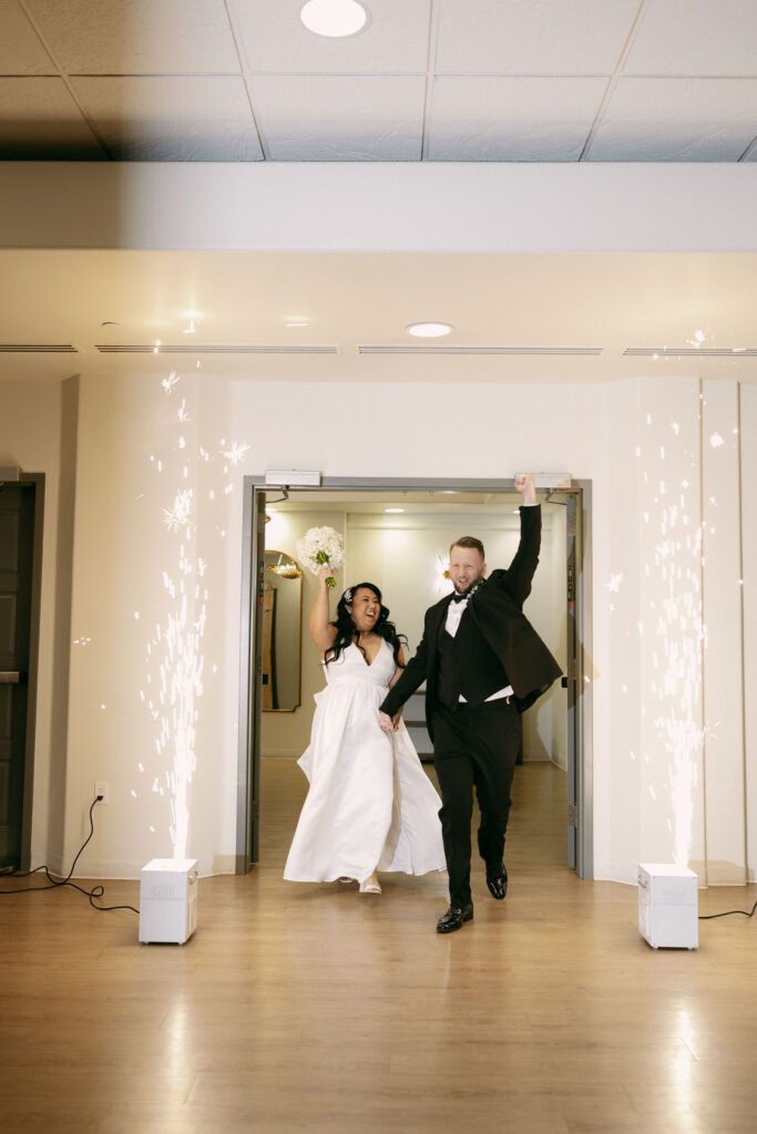 Bride and groom entering their wedding reception