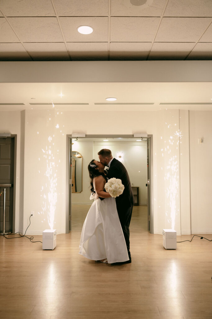 Bride and groom kissing during their grand entrance