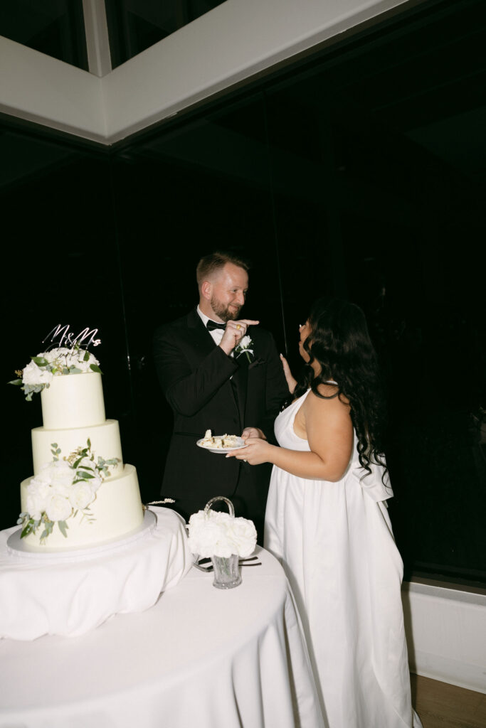 Bride and groom cutting into their wedding cake