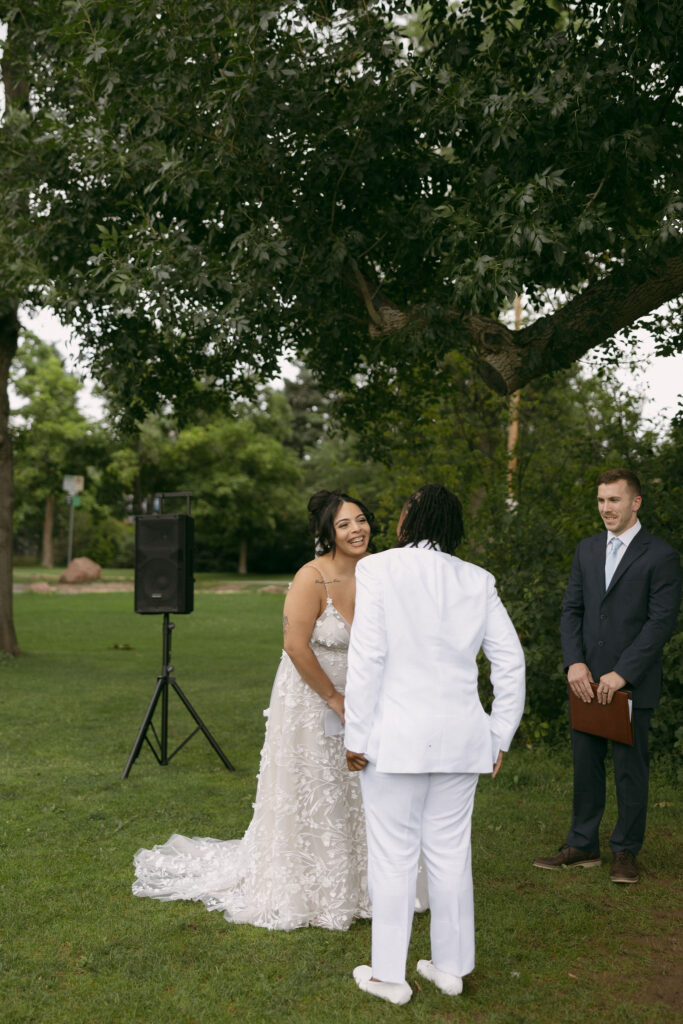 Woman laughing during their intimate outdoor wedding ceremony