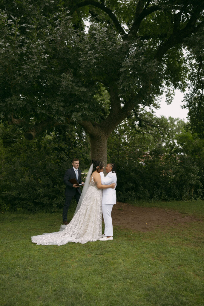 Couple going in for a kiss during their Chautauqua Park, Boulder, CO wedding ceremony