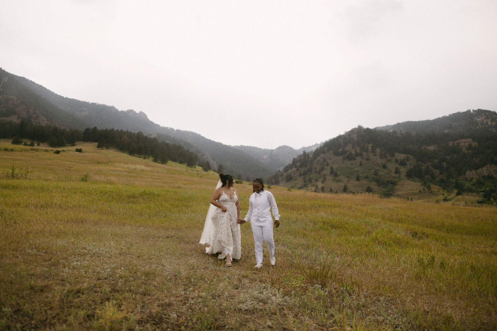 Couple walking back down from the mountains during their Chautauqua Park wedding portraits