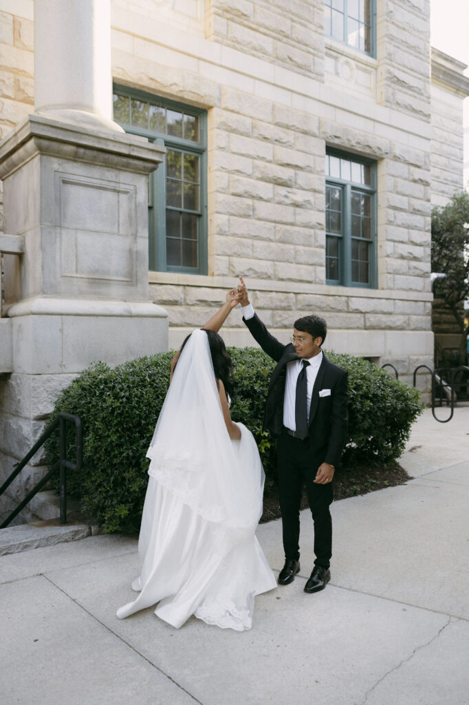 Bride and groom dancing during heir Historic DeKalb Courthouse wedding portraits